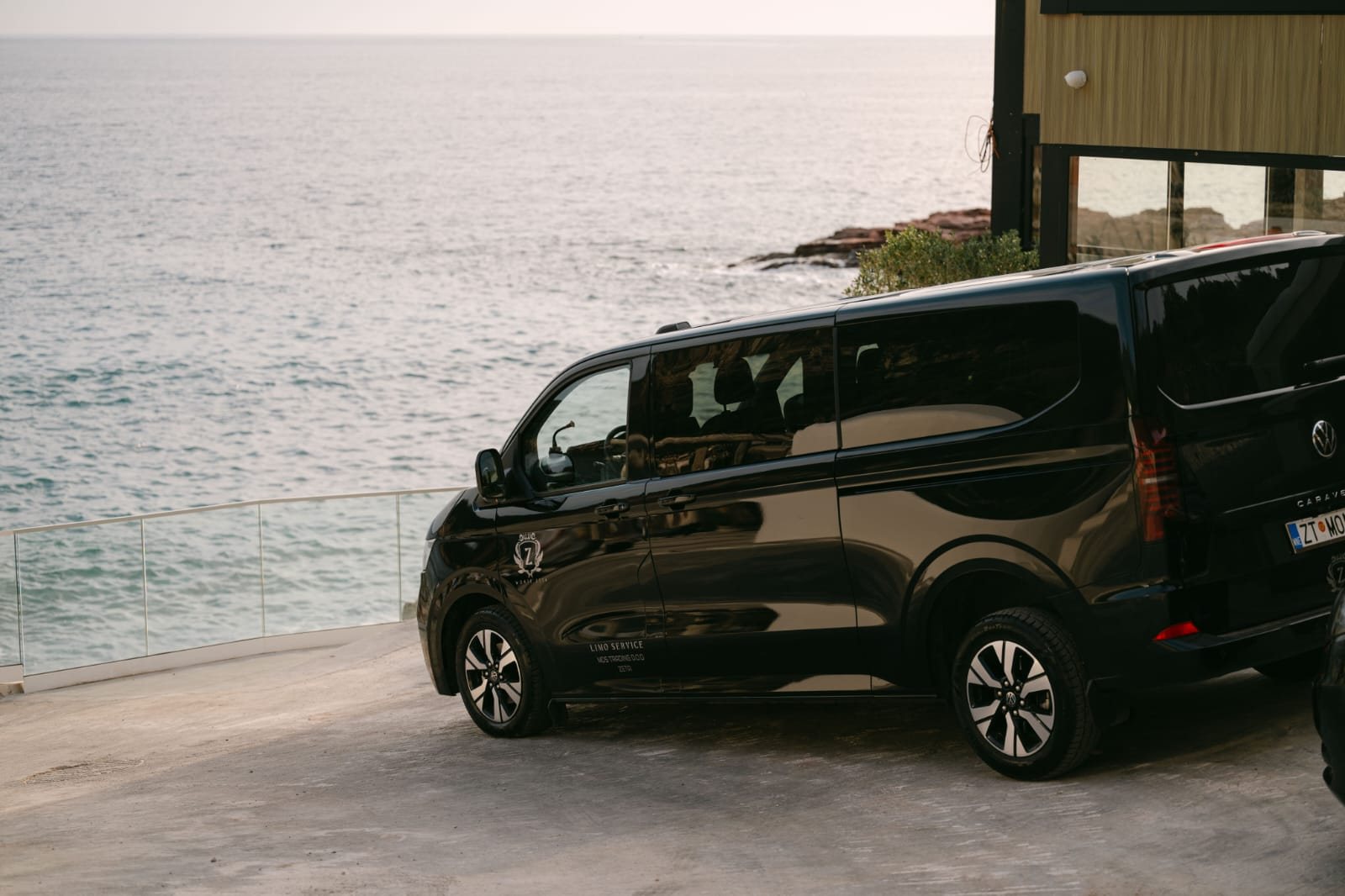 Black Volkswagen Caravelle of Monte Zeta parked above the Adriatic sea in Montenegro
